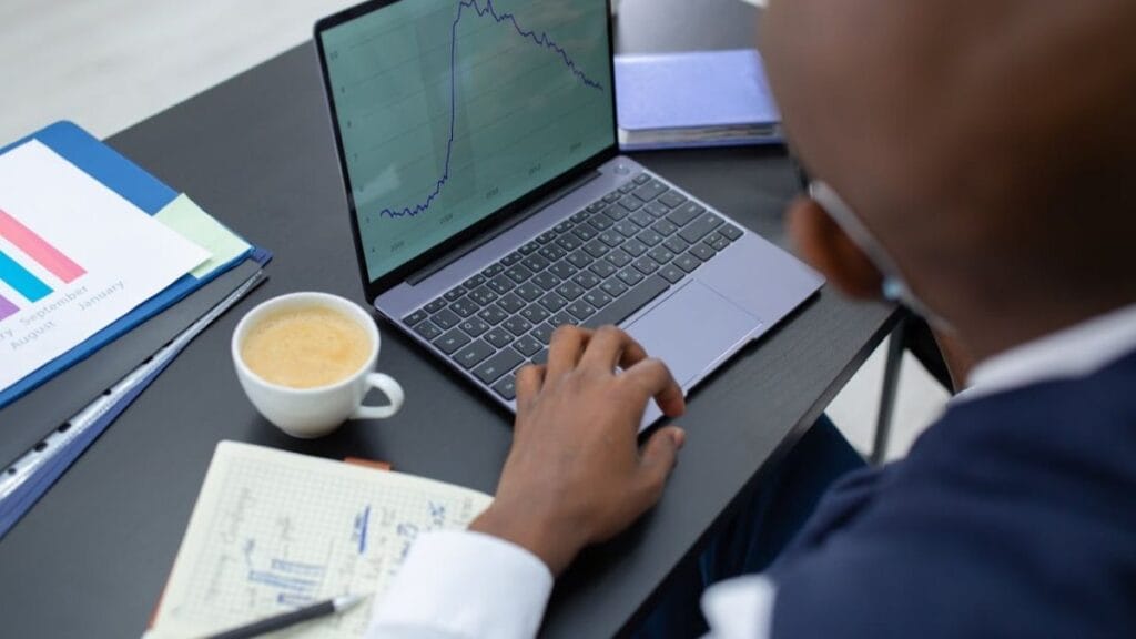 man using his digital skills working on his laptop at his workplace.