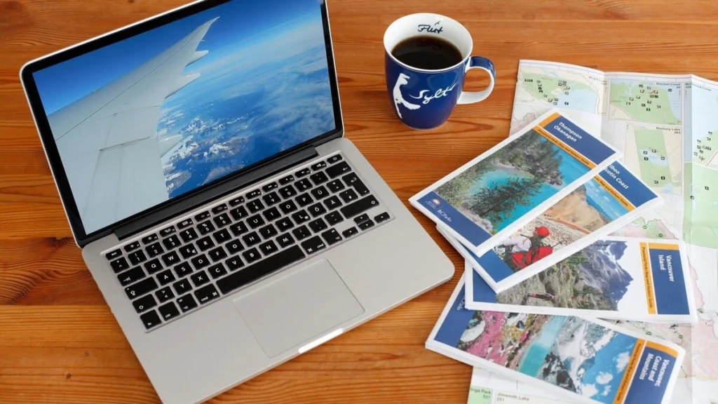 Travel Planning with City Maps and laptop with a cup of coffee