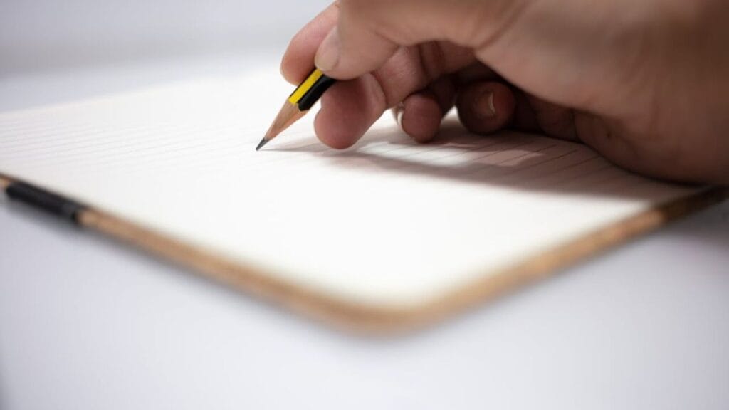 closeup of a hand holding a pen and writing