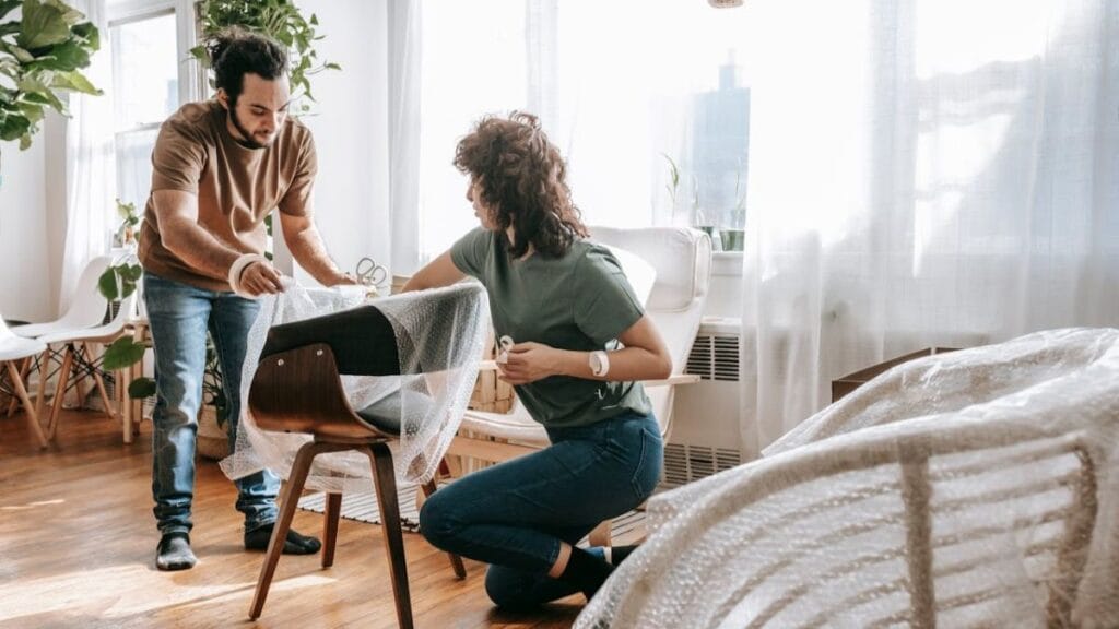 couple arranging furniture in a house