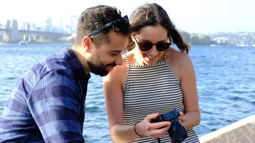 couple taking photographs at waterfront