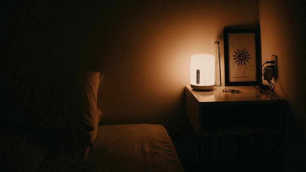 dimly lit room and aroma diffuser on the bedside table for a calm sleep in a comfortable home