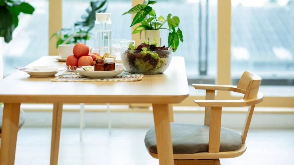 healthy food and water placed on a table with natural light on it