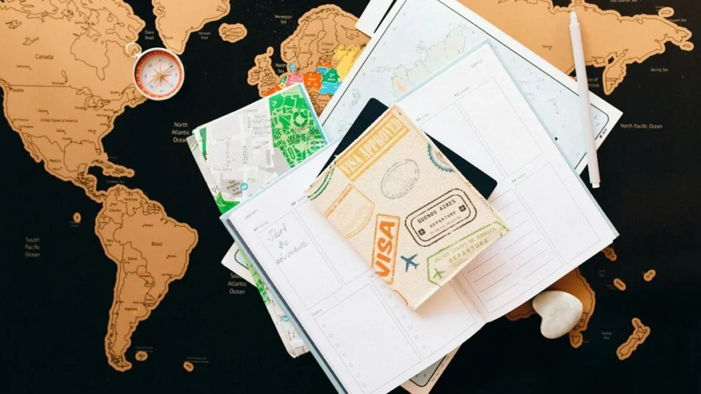 Travel Planning on a journal with maps and compass