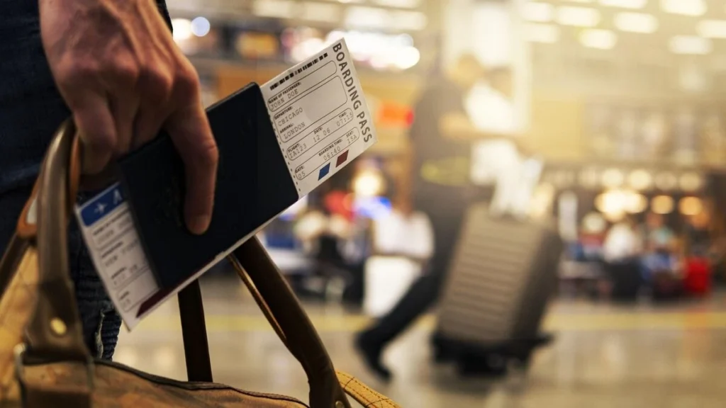 person at airport with passport and boarding pass