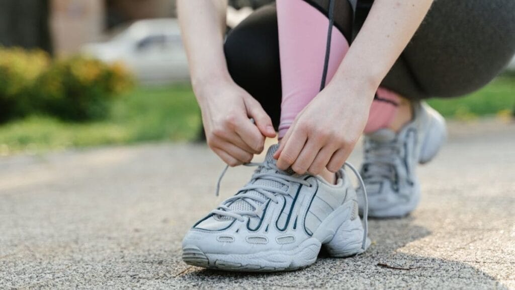 person tying shoelace