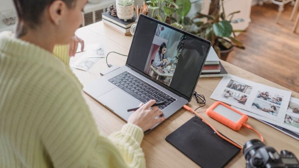 woman photographer creating digital assets on her laptop