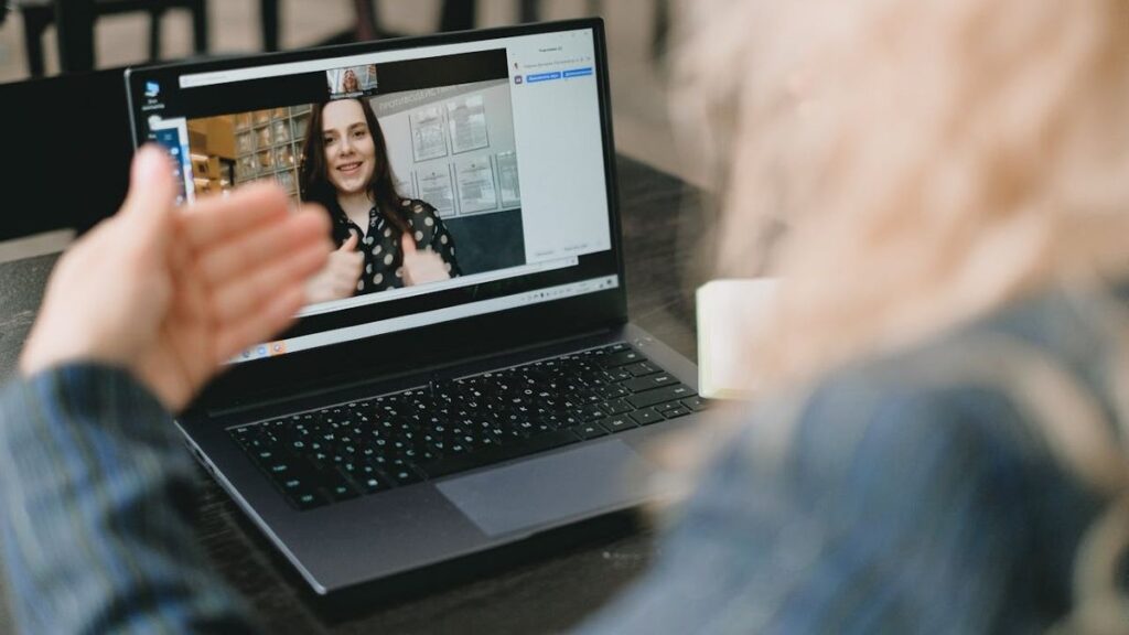 two office workers having discussion in an online meeting