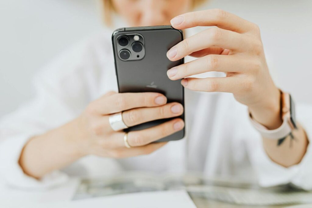 woman looking at online content on the screen of her phone.